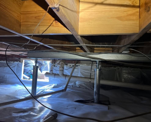 vapor barrier with support jacks under home in Goldsboro