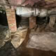 wet and old shredded vapor barrier found during inspection in crawlspace on Wesley Dr in Chapel Hill